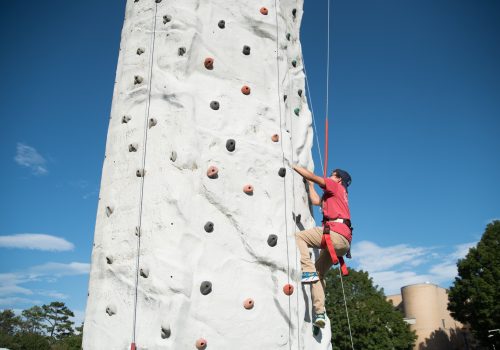 Students on the climbing wall at Rockypalooza