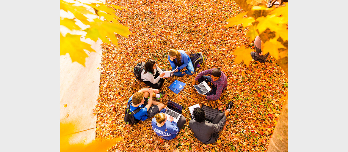 Students among fall leaves