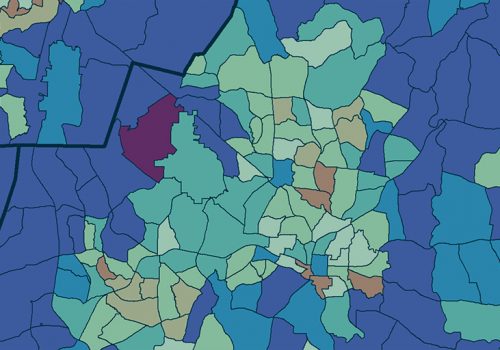 Close-up of a student writing code on a laptop.