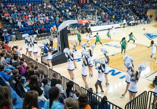 UNC Asheville cheerleaders performing at a basketball game