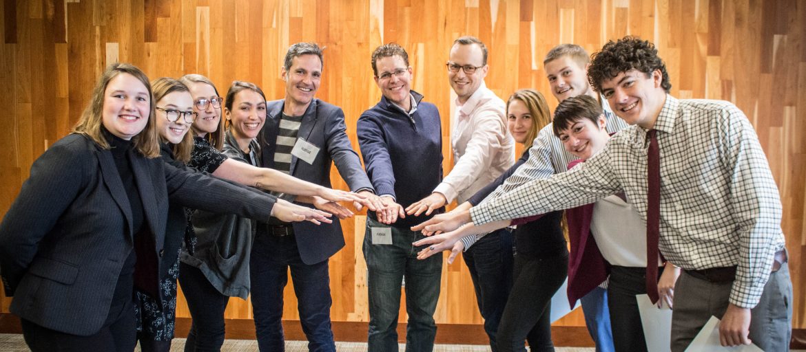 A group of people putting their hands together