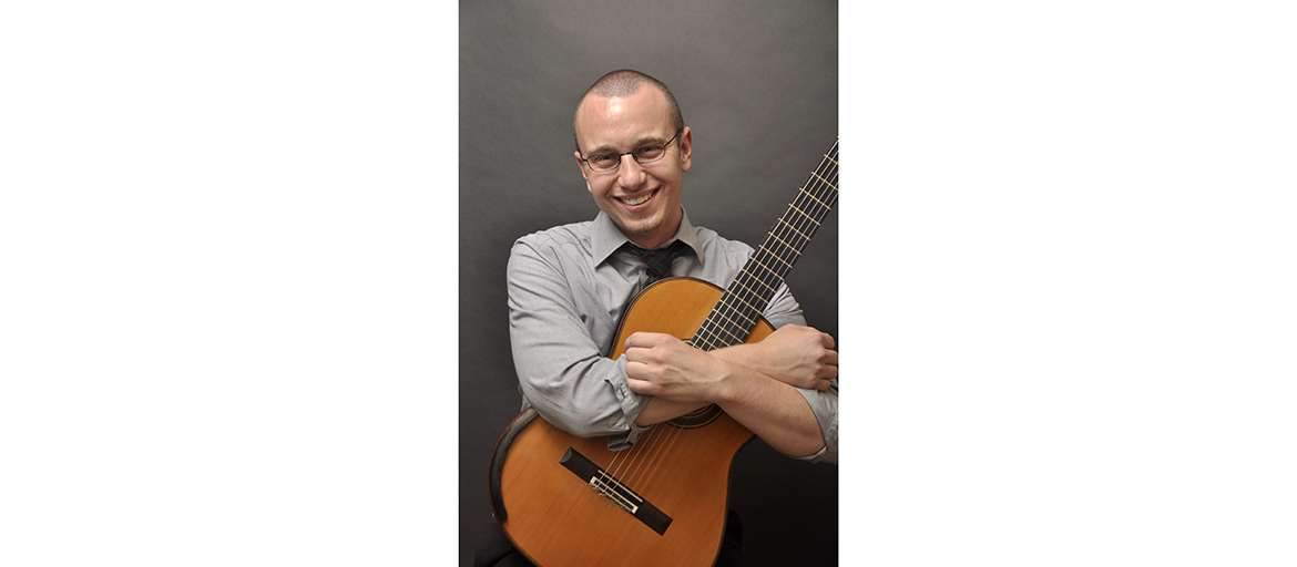 Andy Jurik holding his guitar