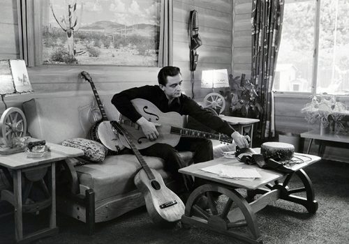 Johnny Cash with guitars at his home in 1960