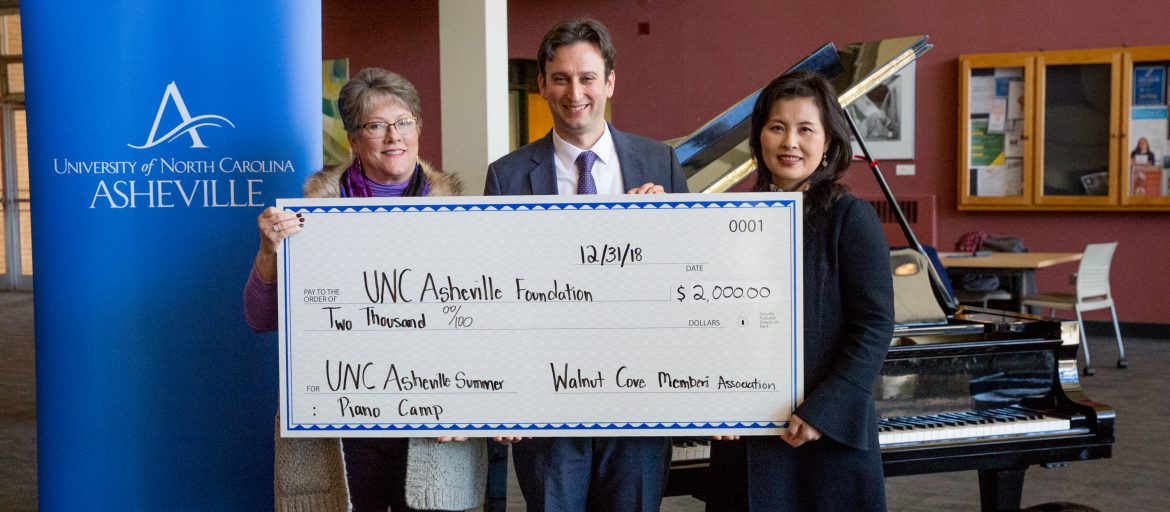 A big check of 2000 dollars to the UNC Asheville Summer Piano Camp
