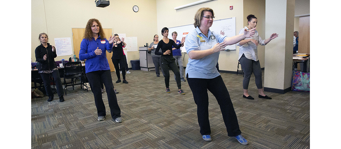 Meghan Bryant led the Tai Chi for Arthritis and Fall Prevention workshop at UNC Asheville. Janice DeMille (dark blue shirt) will teach the program in Marion.