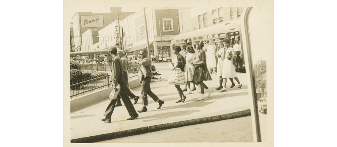 DowntownBus-RicePrints028 (1) Photo shows well-dressed African Americans crossing a downtown Asheville street; part of the Isaiah Rice Collection