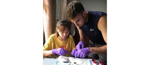 two people dissecting a frog