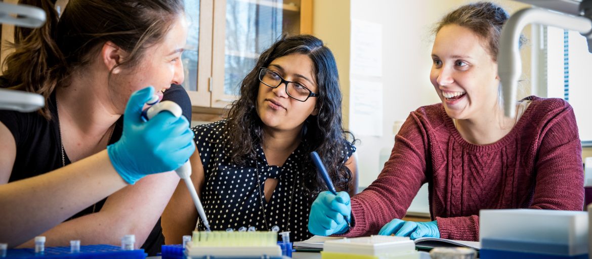 three women in a science lab