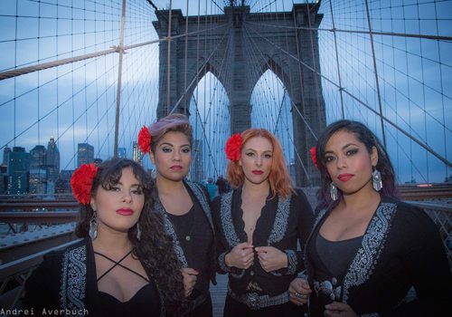 Flor de Toloache band members pose on the Brooklyn Bridge