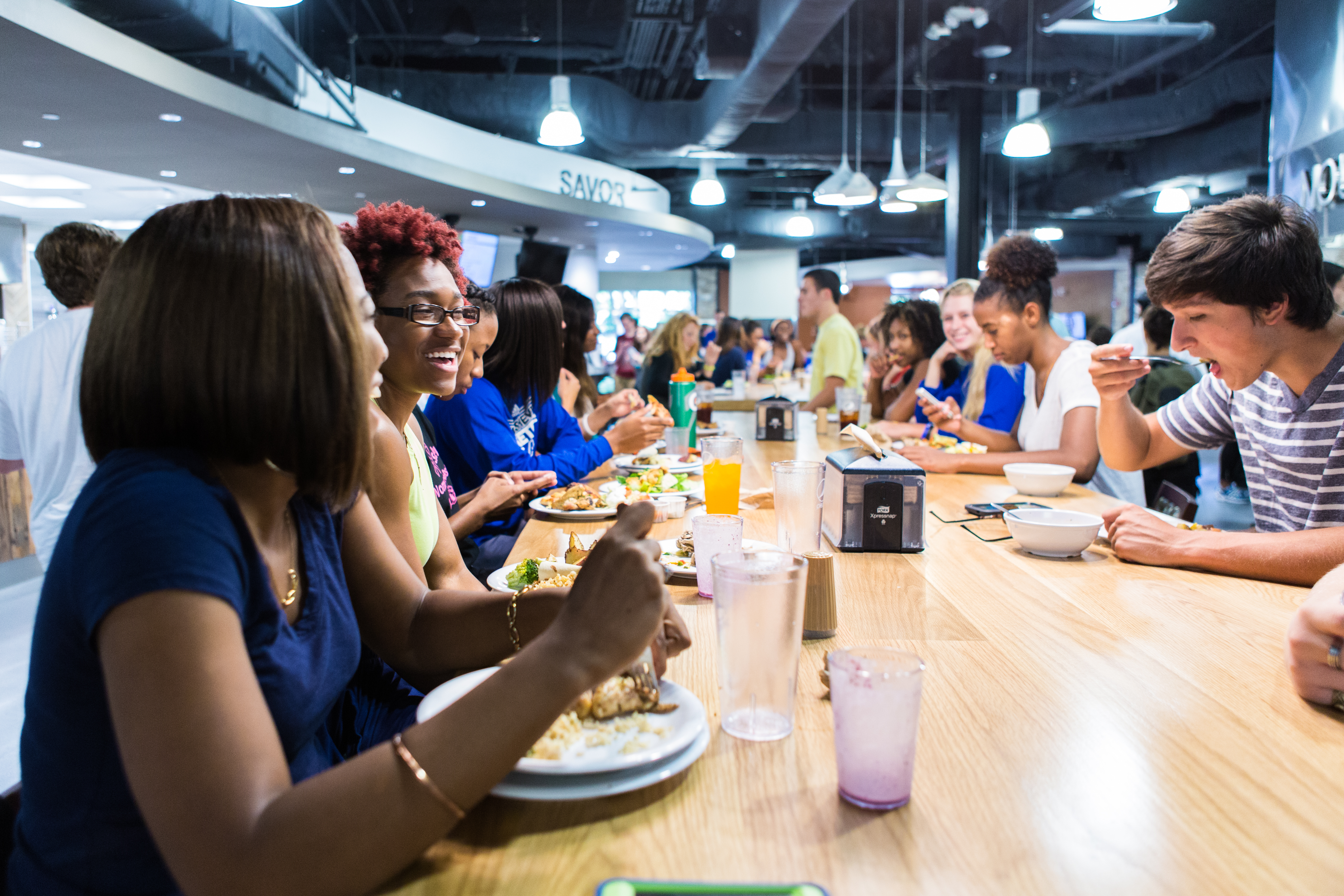 Brown Dining Hall students eat and laugh in a dining hall