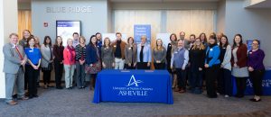 Blue Ridge Community College graduates now will have a direct admission option to North Carolina’s public liberal arts and sciences university with the Transfer Promise Program at UNC Asheville. Blue Ridge President Laura Leatherwood and UNC Asheville Chancellor Nancy J. Cable signed a memorandum of understanding on November 5, 2019, bringing the neighboring higher education institutions into a collaborative and creative partnership focused on student pathways to success. “UNC Asheville’s academic partnership with Blue Ridge Community College reinforces our commitment to help students transition to four-year university work seamlessly,” said UNC Asheville Chancellor Nancy J. Cable. “Our Transfer Promise Program is the latest initiative designed to provide students with a convenient and affordable path to continue their university education at UNC Asheville.” Building on the North Carolina Comprehensive Articulation Agreement (CAA), the Program will allow currently enrolled Blue Ridge Community College students a direct-entry pathway to UNC Asheville available upon graduation from Blue Ridge Community College. There is no fee to participate. The Program affords Blue Ridge students access to information about academic programs, faculty, and staff at UNC Asheville who will facilitate their transition to a bachelor’s degree program. “Our students here at Blue Ridge are incredibly hard-working, and we’ll do anything we can to help make their transition to a four-year university like UNC Asheville easy and smooth,” stated Blue Ridge President Laura Leatherwood. Blue Ridge Community College is consistently among the top three institutions for transfer students seeking the original liberal arts and sciences education offered at UNC Asheville, which includes unique programs such as the mechatronics engineering program, offered jointly with NC State. Both Blue Ridge and UNC Asheville offer mechatronics as part of their curriculum, and transfer students can also choose from more than 30 majors and minors at UNC Asheville. Students who wish to participate in the Program must satisfy the following conditions: •Be a currently enrolled student at Blue Ridge in a degree-seeking capacity; • Submit UNC Asheville application for admission and disciplinary forms by UNC Asheville deadlines; • Submit application fee or waiver and fulfill all commitment actions steps; • Be in good standing at Blue Ridge and other institutions attended; • Demonstrate good citizenship and conduct; • Earn and maintain a minimum cumulative GPA of 2.50 at Blue Ridge and a minimum GPA of 2.20 in their most recent term; and • Earn an Associate's degree from Blue Ridge in a college transfer program or in an applied program for which an articulation agreement exists. • Enroll at UNC Asheville within one academic year (within the next two regular terms (fall/ spring semesters) of completion of the Associate's degree). UNC Asheville also has established a Bulldog Trailblazer Promise Program with Asheville-Buncombe Technical Community College. Both Promise Programs guarantee admission to UNC Asheville for those who complete the AA or AS degree at either school, provided all eligibility requirements above are met. The Programs prioritize the ability to get admission, financial aid, and registration services communicated early in the transition process, which sets students up for maximum success at both institutions. For more information, visit https://www.unca.edu/admission/apply/partnerships/.