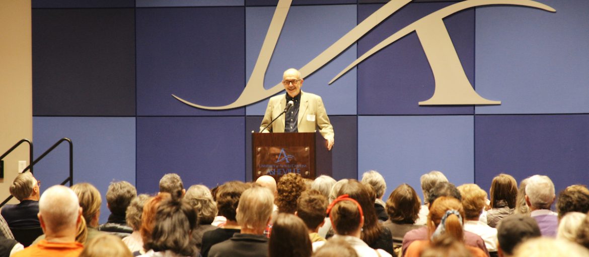a man at a podium in front of a crowd