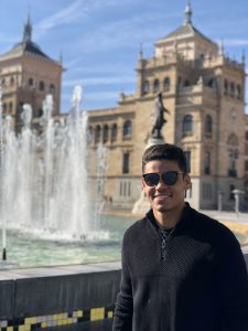 a man in front of a fountain