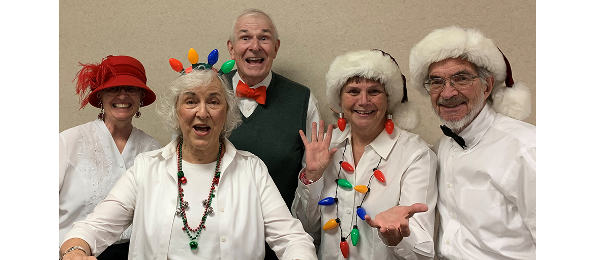 RCSHoliday2019-web Members of the choir pose with Santa hats and holiday garb