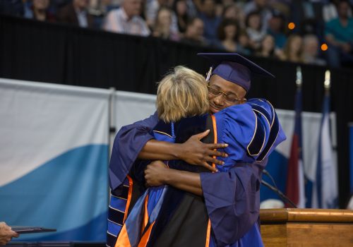 Student hugging Chancellor Cable at Commencement