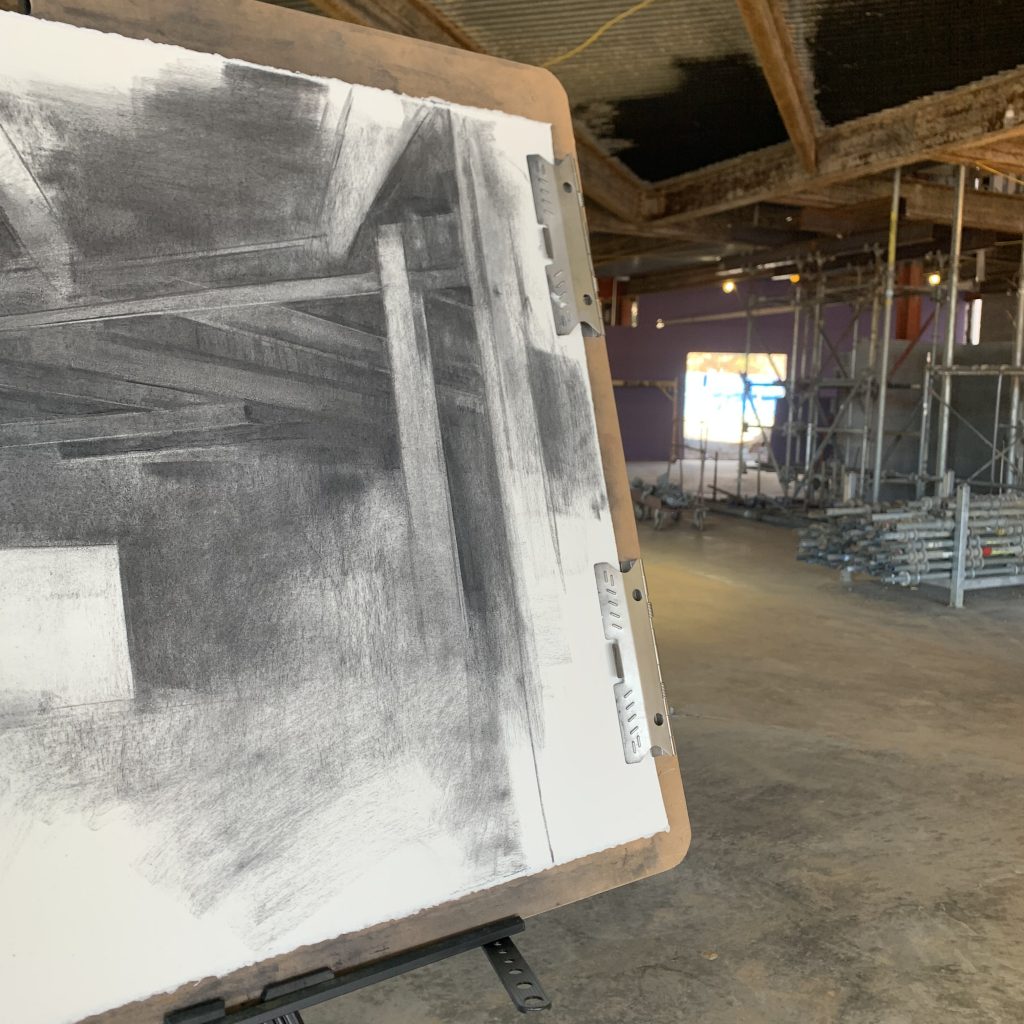 beldue drawing with construction scene and pile of pipes in the background