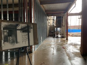 drawing on easel stands on damp concrete