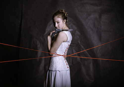 Arden Stockdell-Giesler poses in period constume with pistol