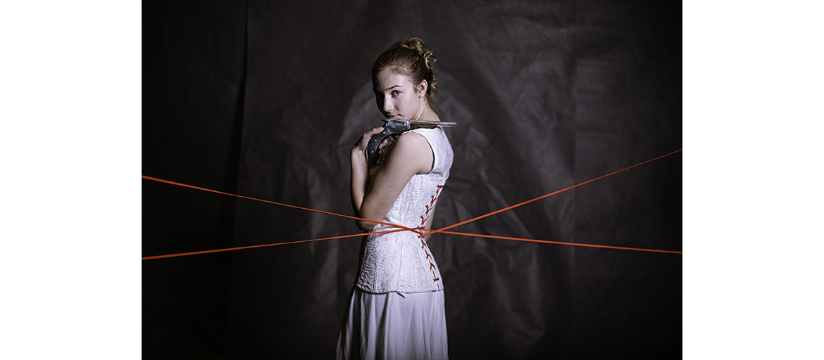Arden Stockdell-Giesler poses in period constume with pistol