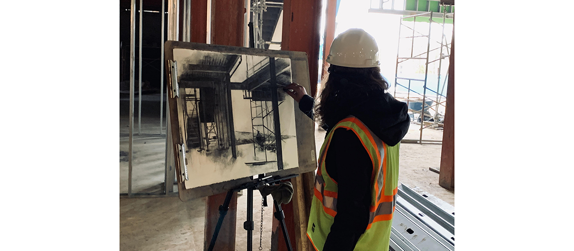 Tamie Beldue drawing at the construction site