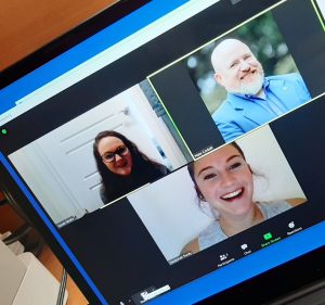 computer screen showing with three faces