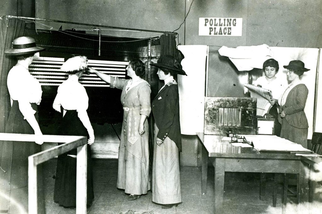women in chicago learning to use a voting machine circa 1915