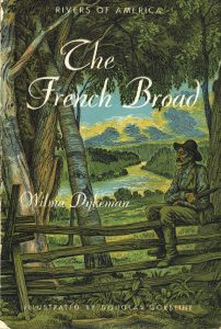 Book cover of The French Broad shows a man sitting on a fence overlooking the river