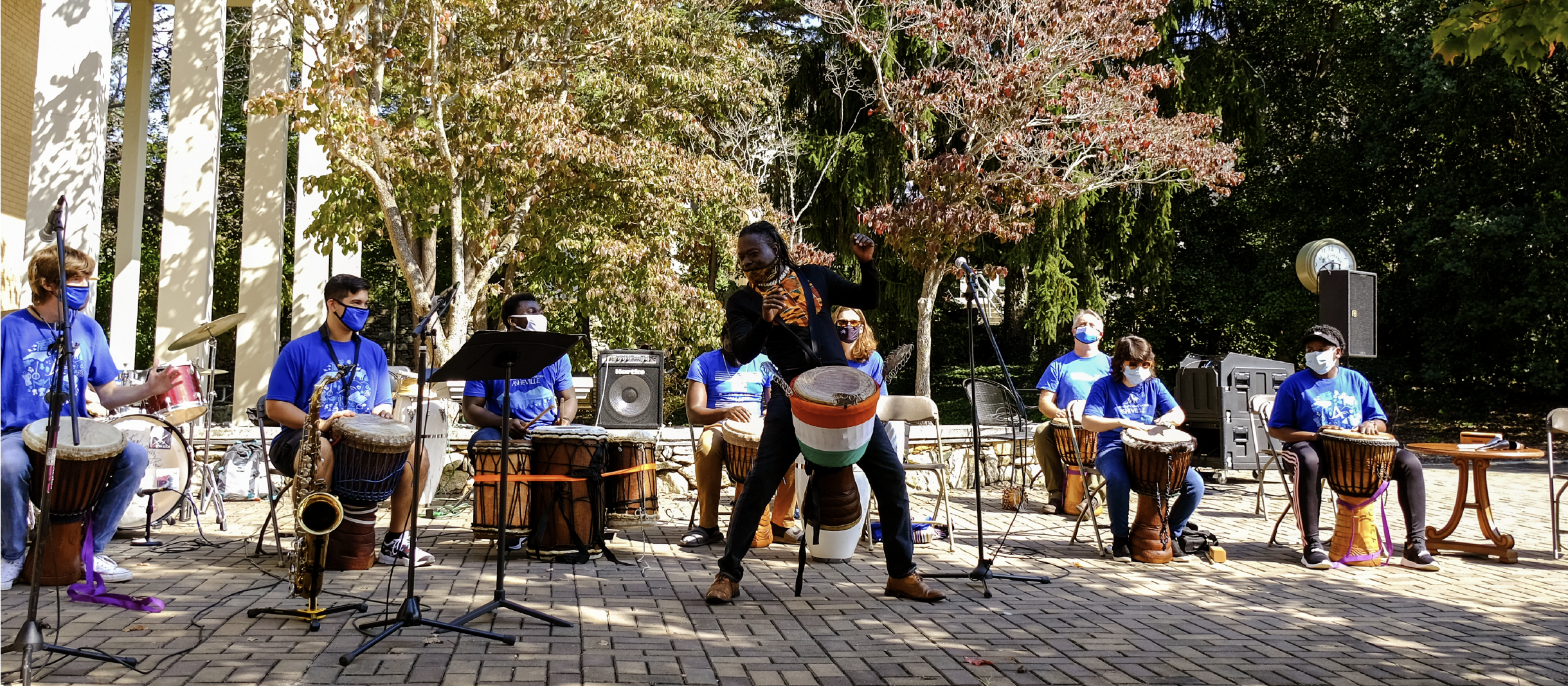 091422_Adama Dembele_v2_event-post_1170x512 Adama Dembele performing in an african drum circle with UNCA students accompanying him.