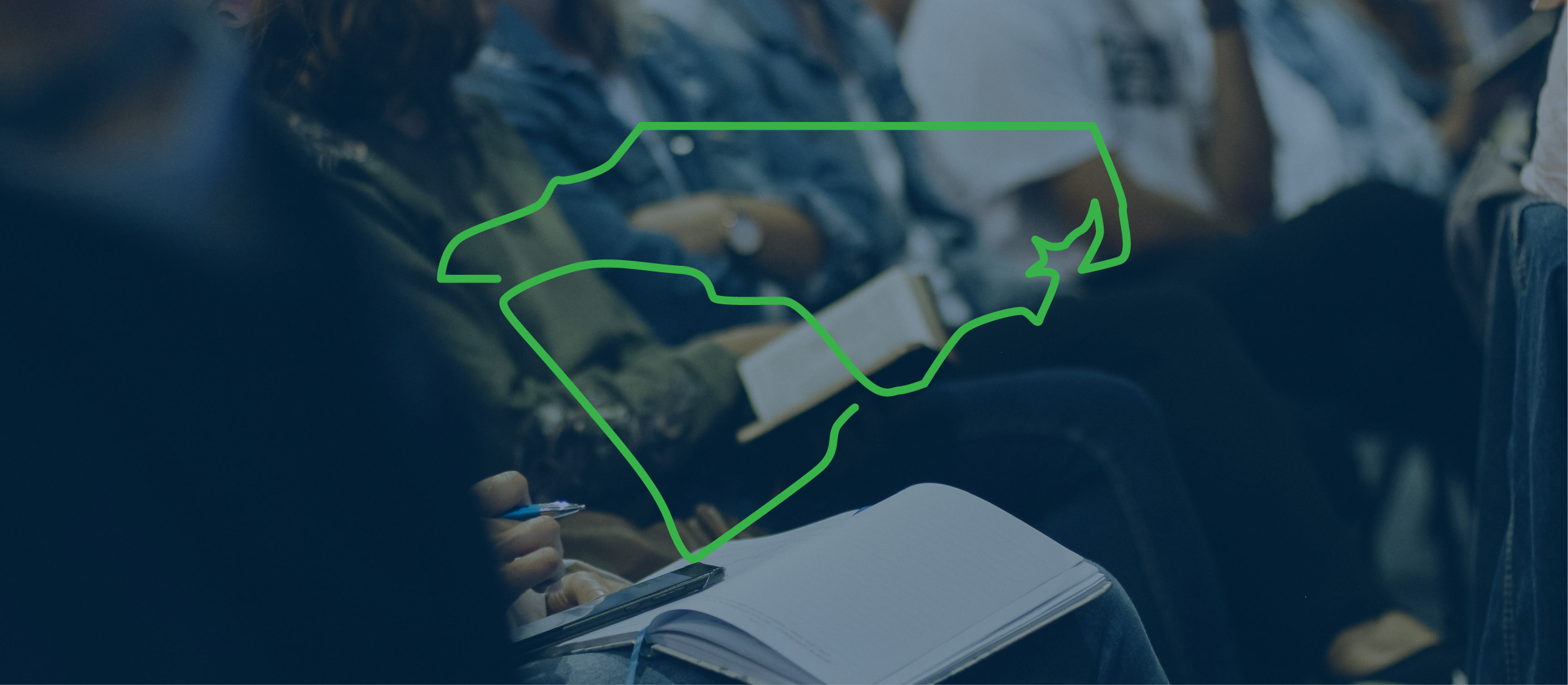 cacrao image of people sitting in an auditorium. The outlines of the states of North and South Carolina overlaid on top of the photo