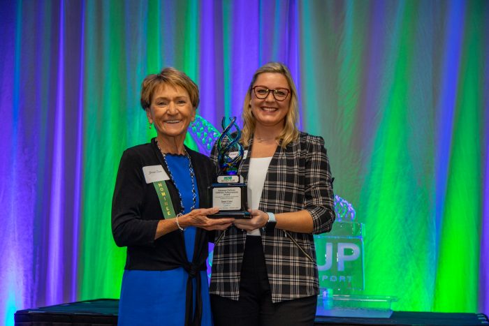 Janet Cone receives the Suzanne DeFerie Lifetime Achievement Award presented by Jessica Juergens, First Bank