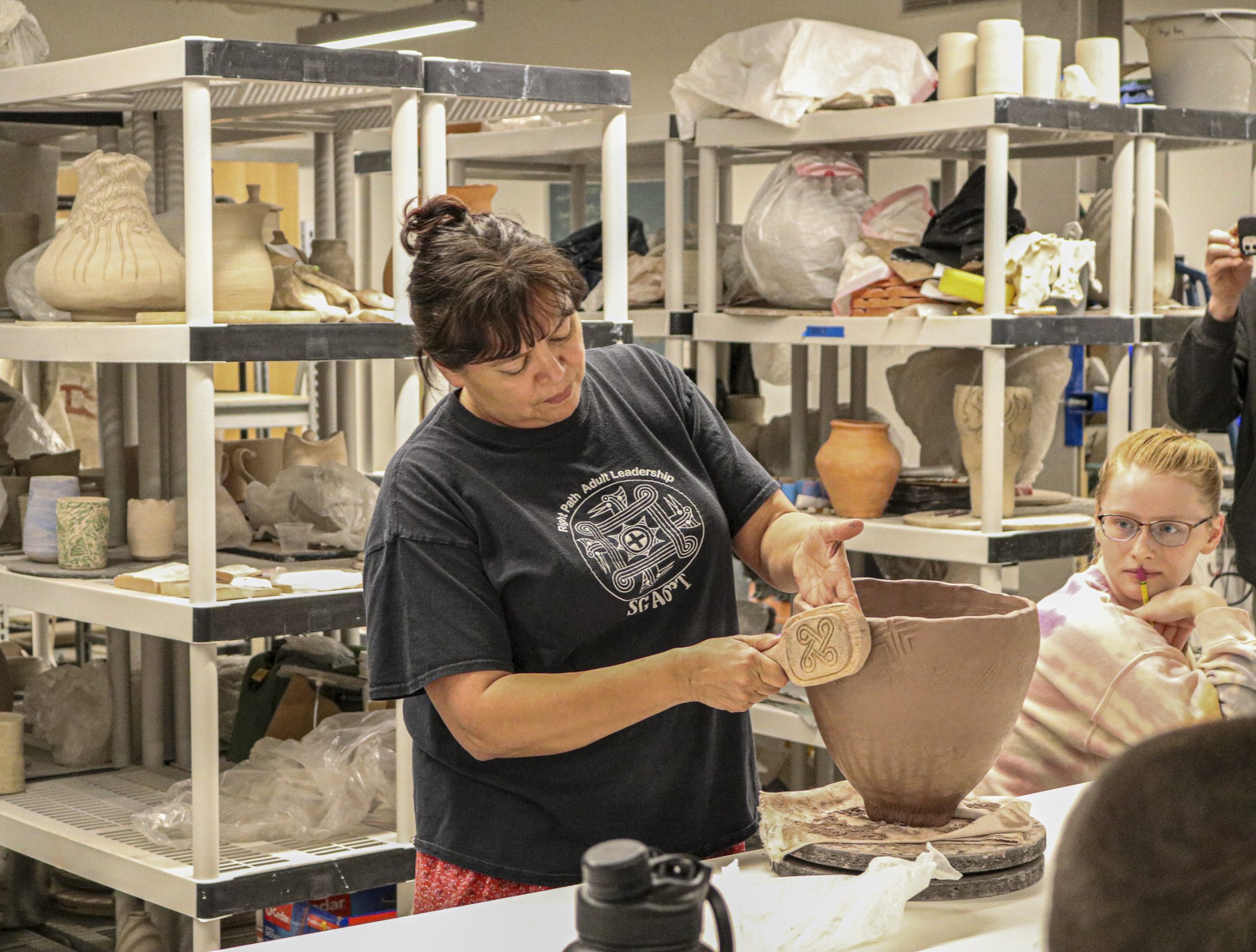 Tara-McCoy-Cherokee-Ceramicist Tara McCoy, Cherokee ceramicist and NEA endowed artist, demonstrates shaping pottery using Cherokee tools and techniques with a class of UNC Asheville students.
