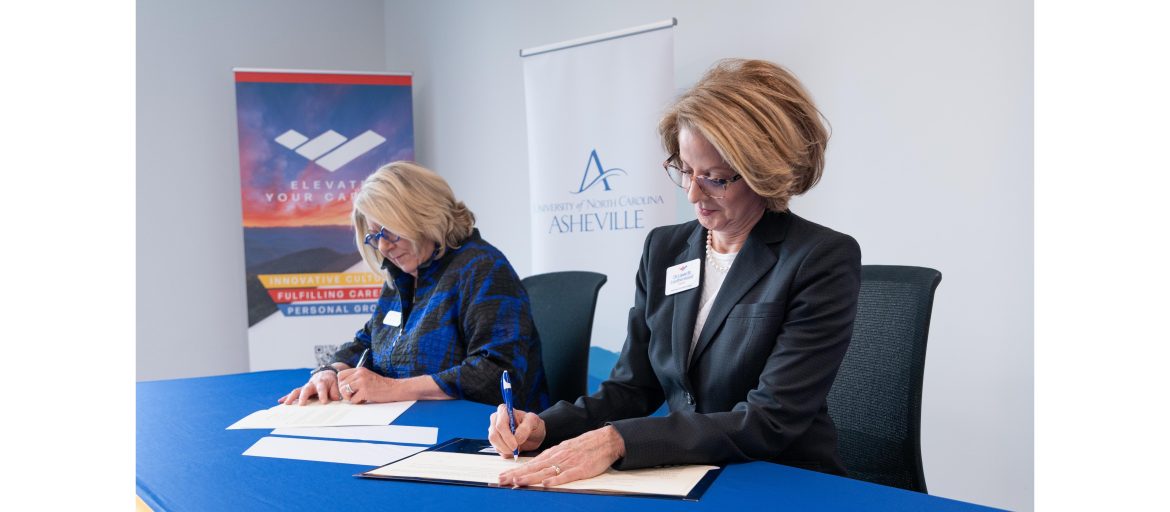 Blue Ridge Community College President Dr. Laura B. Leatherwood (right) signs a direct admissions agreement alongside UNC Asheville Chancellor Kimberly van Noort (left). (Photo by: Benjamin Rickert, Blue Ridge Community College.
