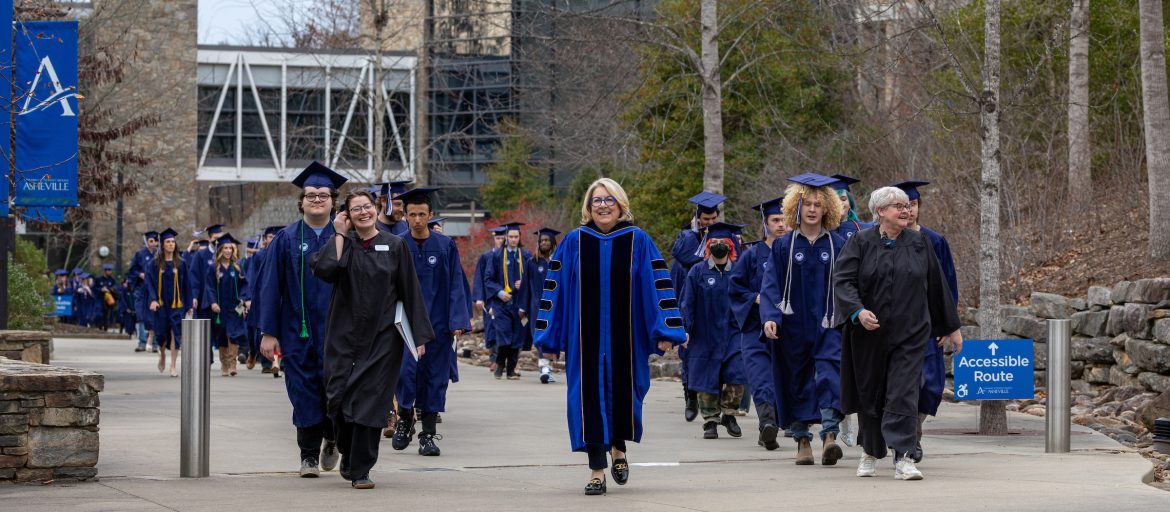 Graduates make their final walk together as students.