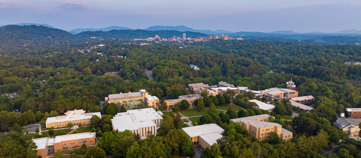 a drone photo of UNC Asheville's campus with downtown Asheville in the background
