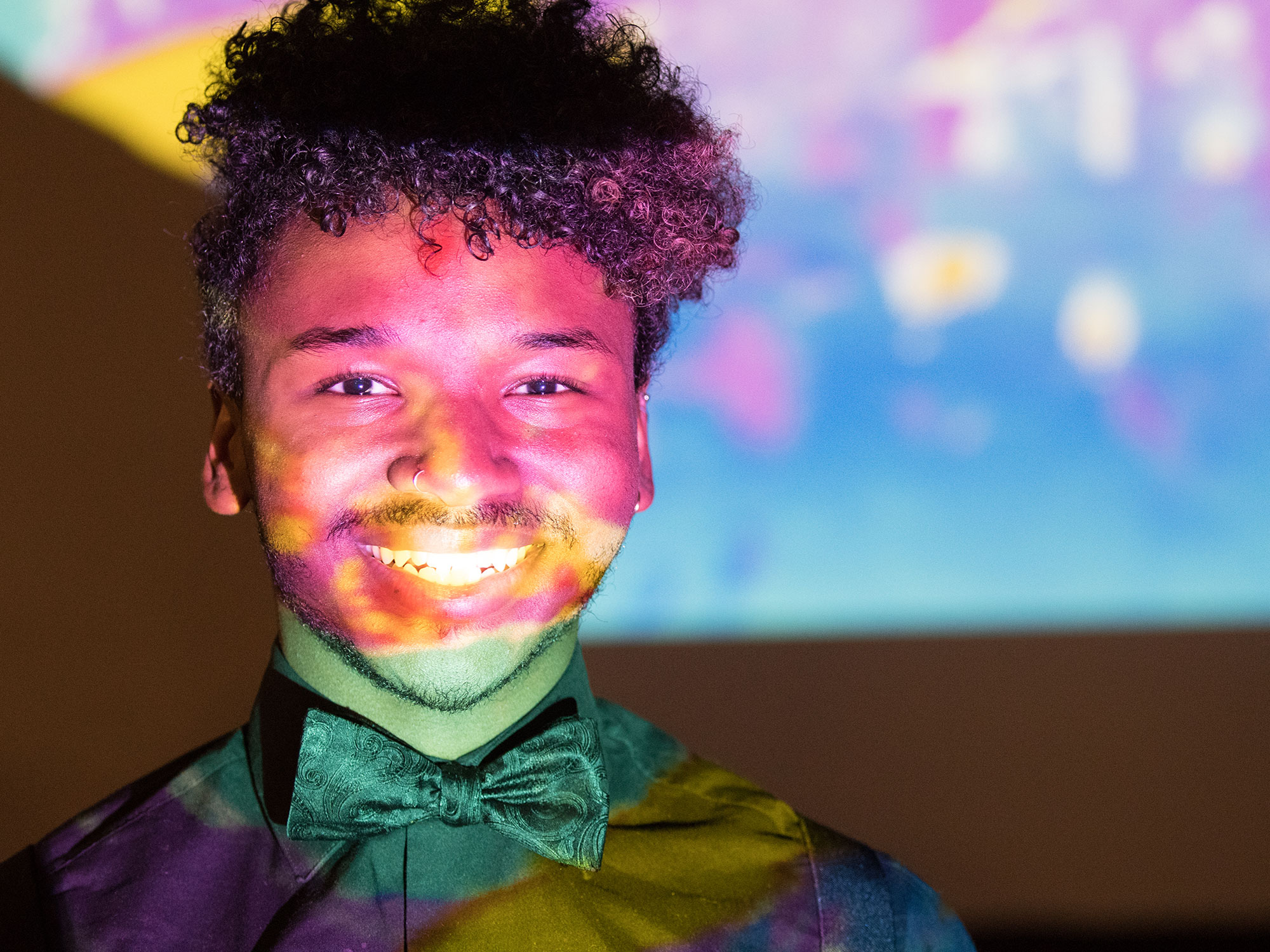 A student standing in front of a projection