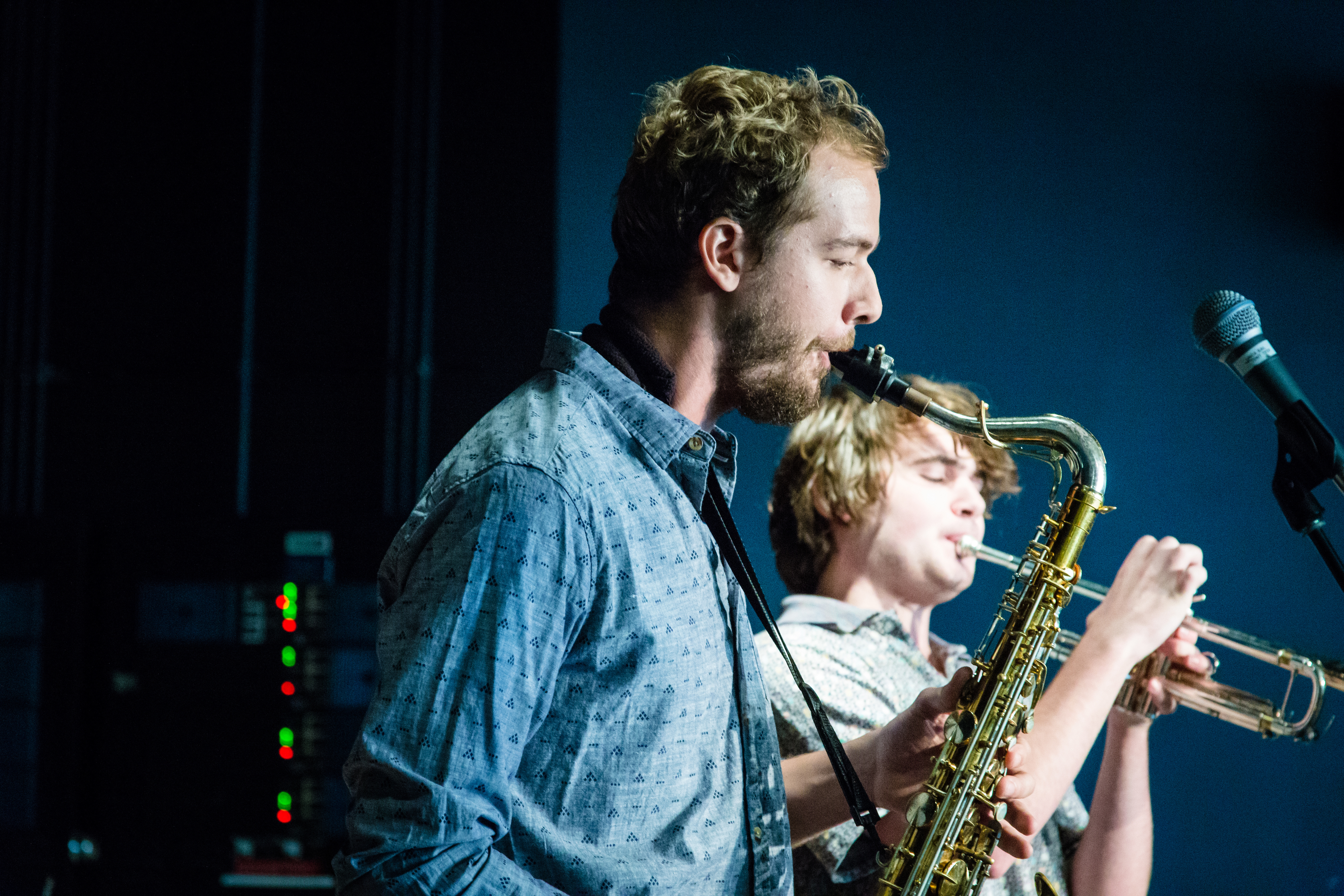 Two students playing on musical instruments.