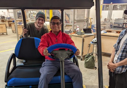 People on a solar powered golf cart in the STEAM studio
