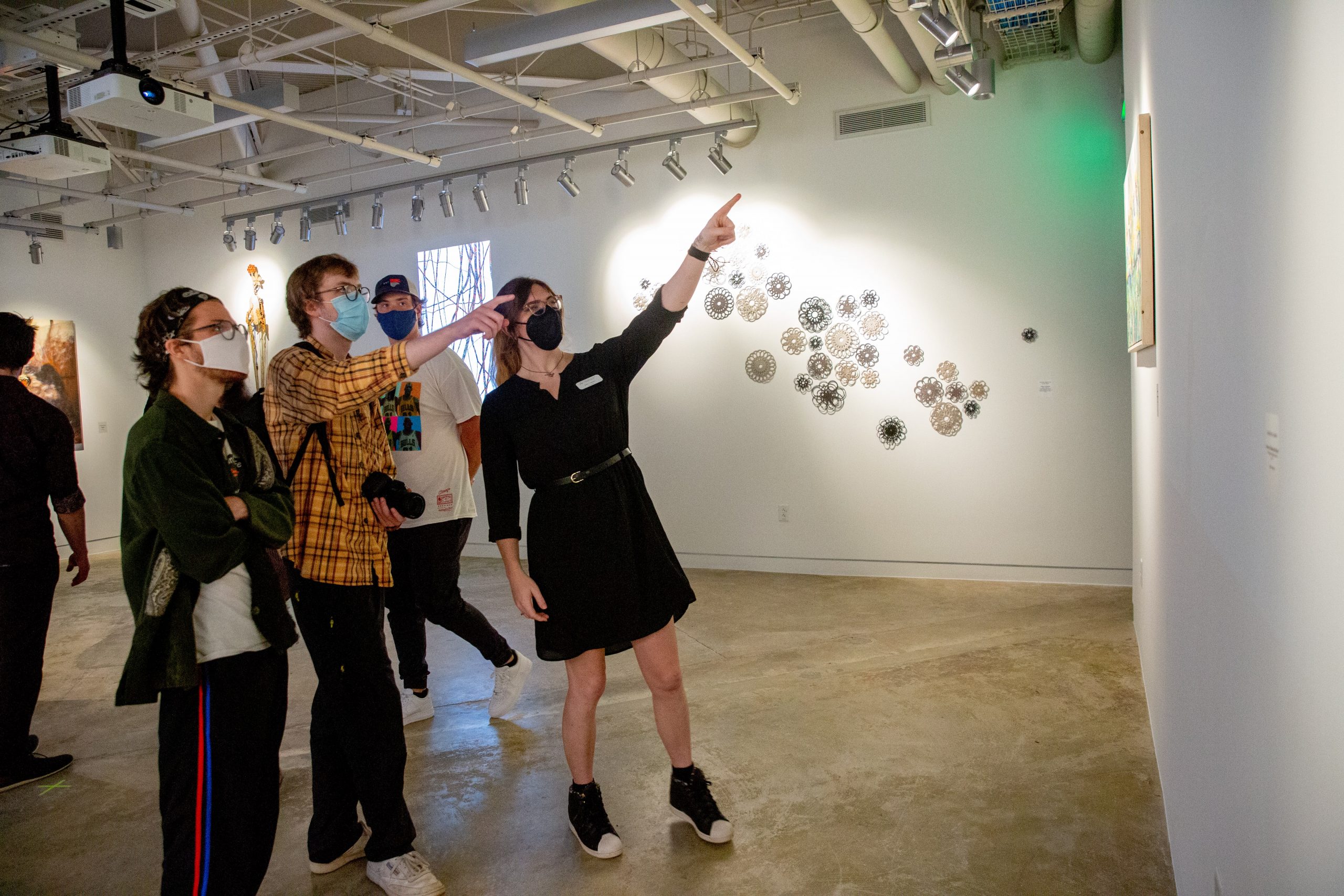 Professor Ashe showing students her art in the New Media gallery
