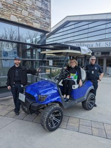 chancellor Van Noort riding in EV golf cart