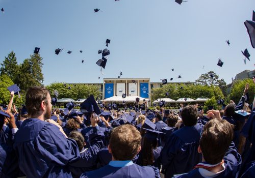 Spring 2018 Commencement hat toss photo shot from behind students
