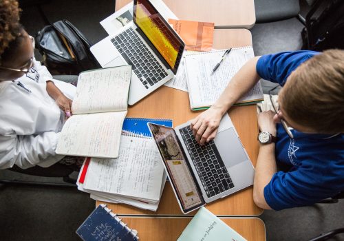 Aerial shot of students working at laptops