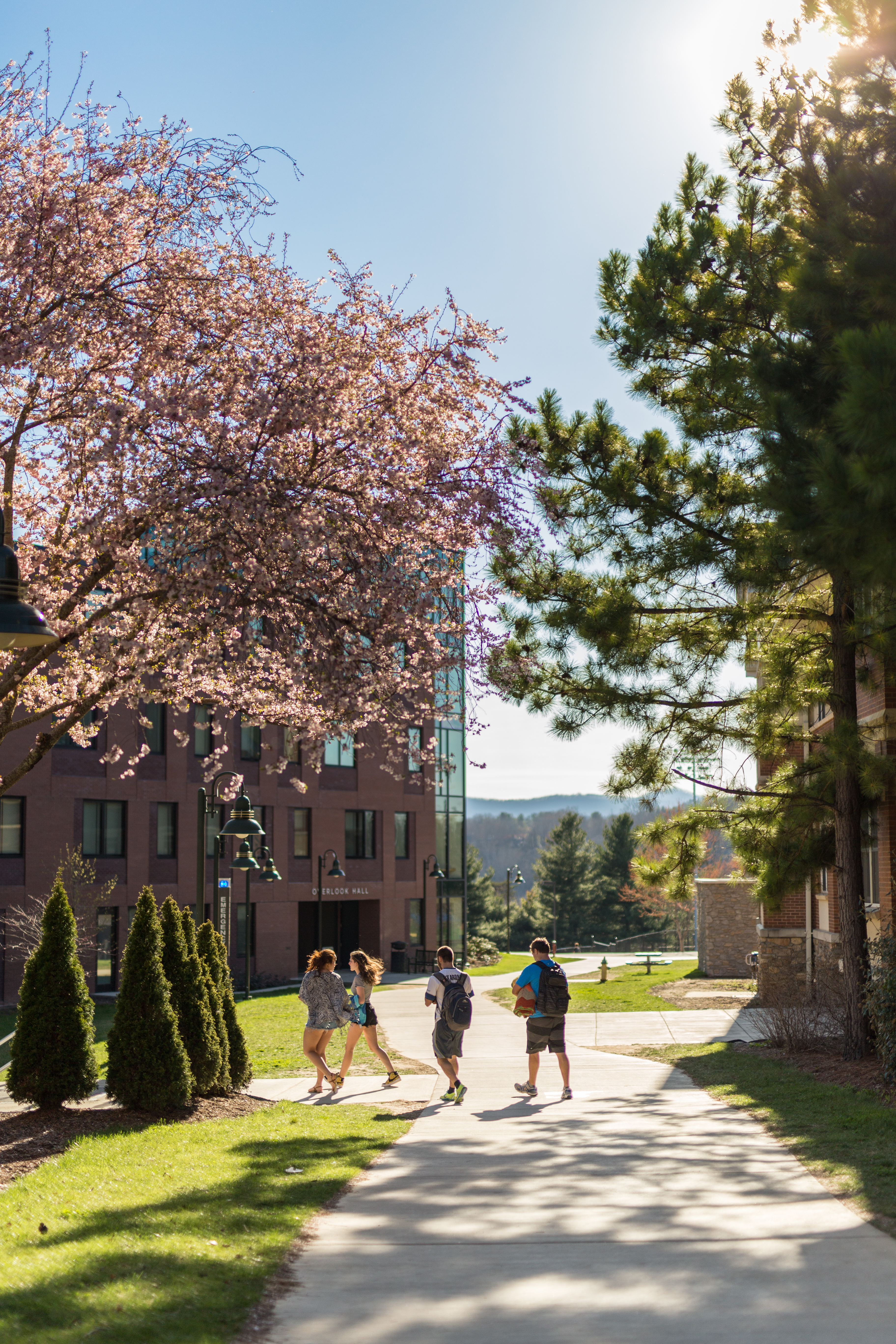 Students walking by Ponder Hall in the spring