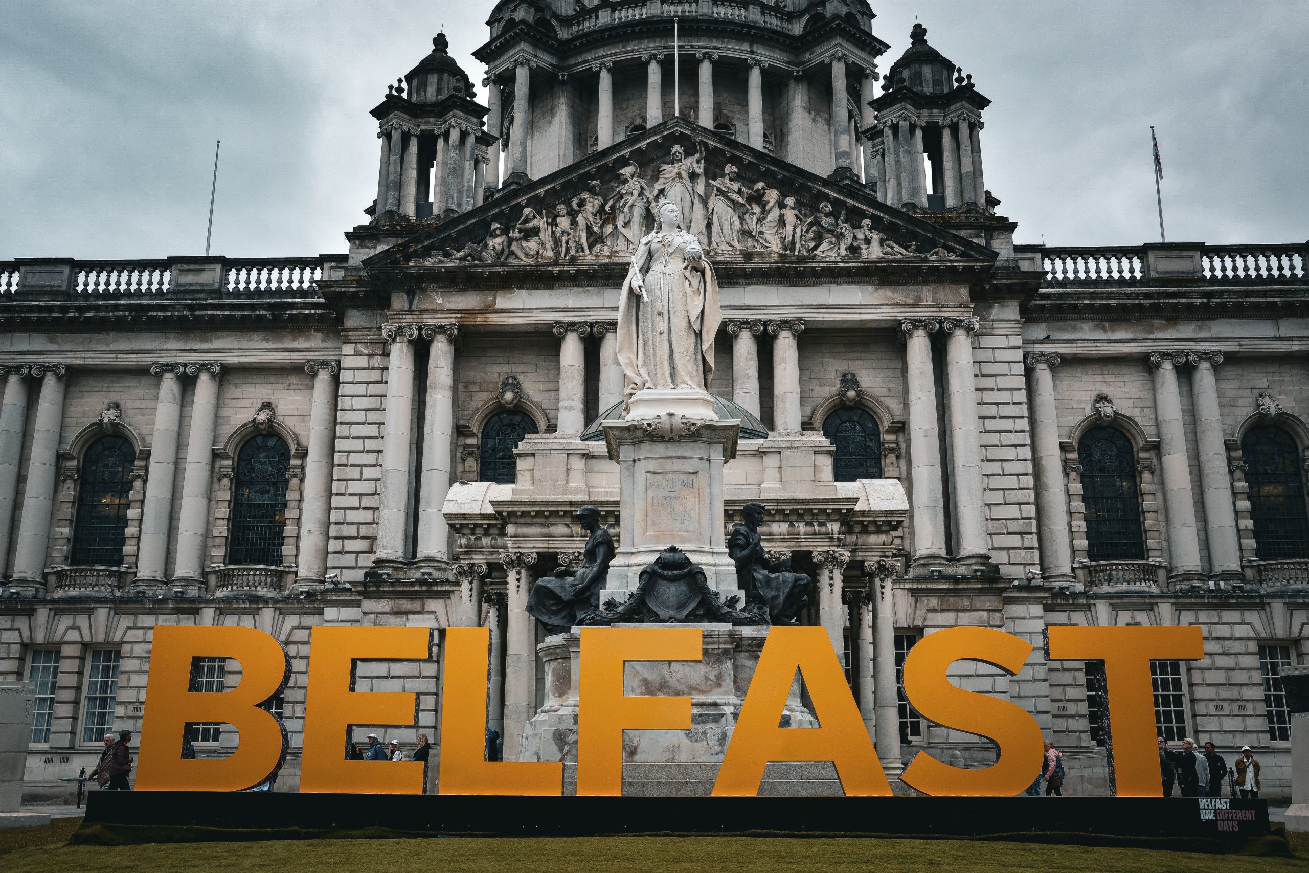 a large orange sign reads Belfast in the city center.