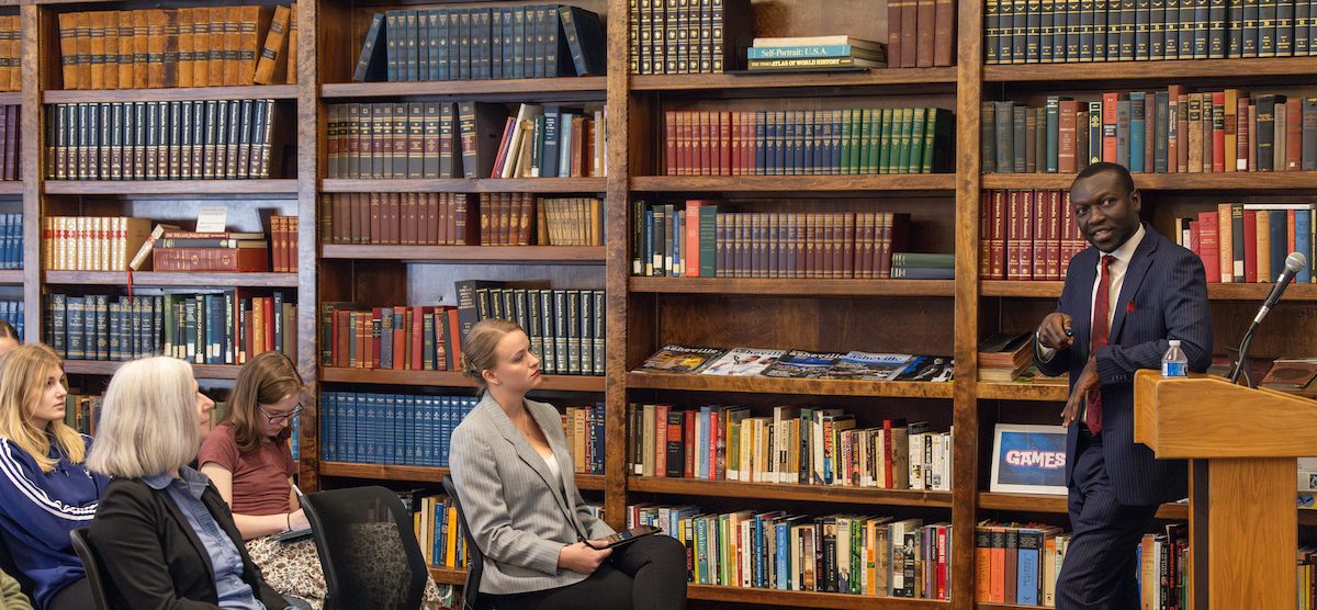 Classroom lecture with books in background