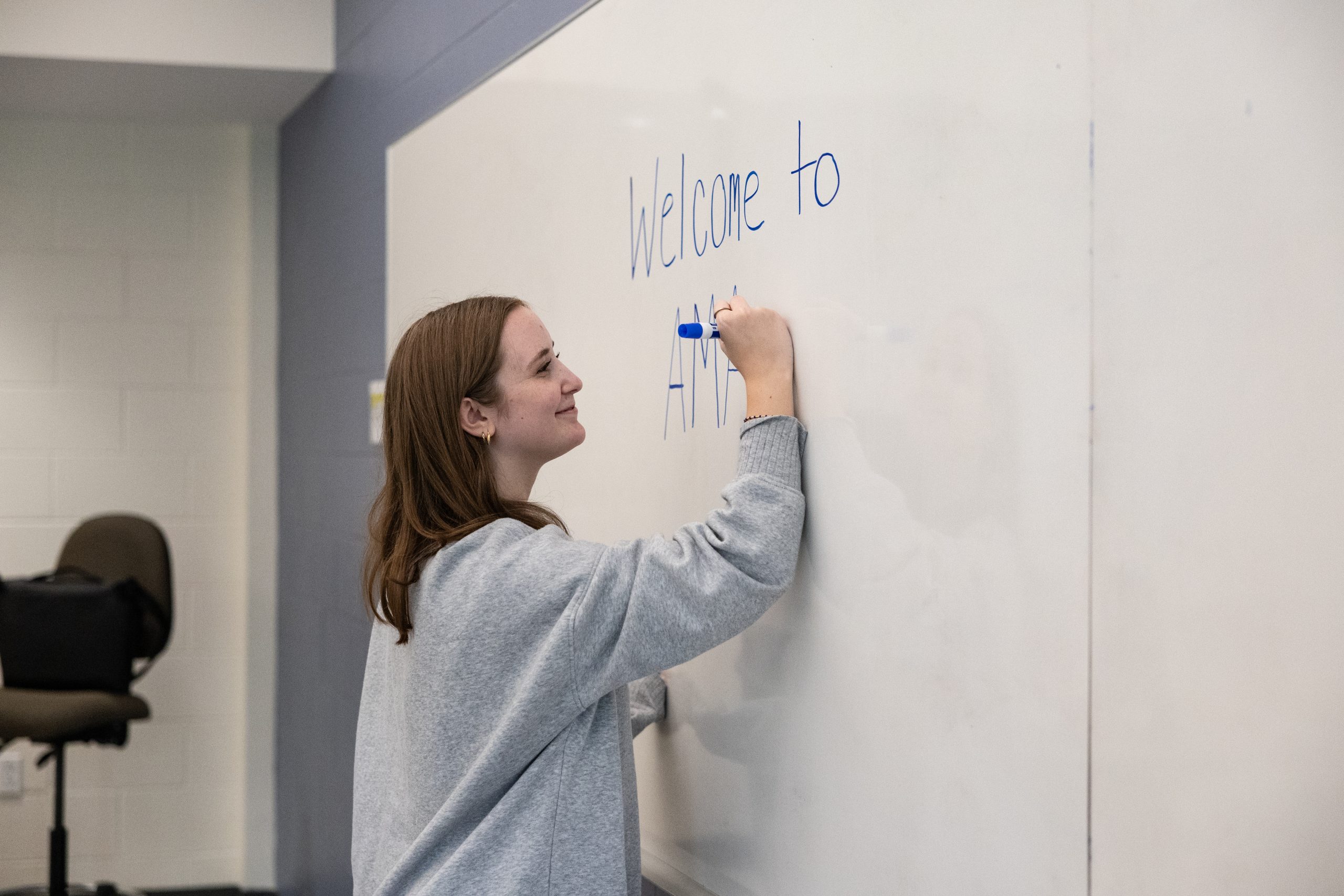 Student writing on whiteboard